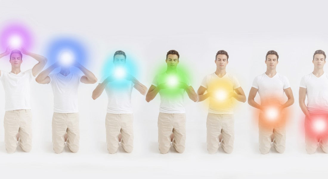 Seven chakra positions holding glowing orbs of different colours.