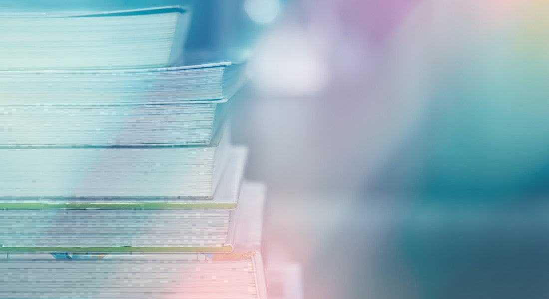 Stack of books with a blurred figure in the foreground symbolising the Akashic Records.