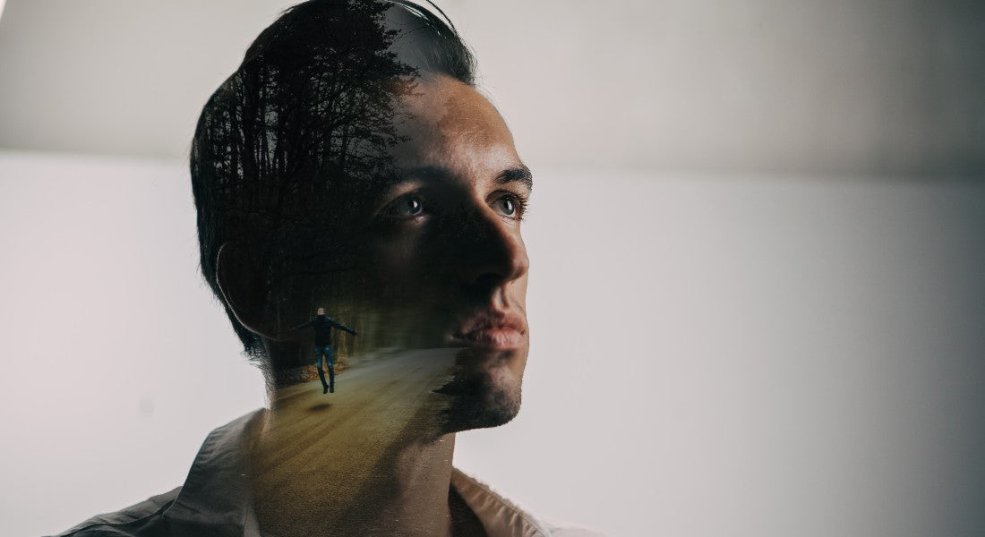 Man's profile with a forest overlay on a plain background symbolising intuition.
