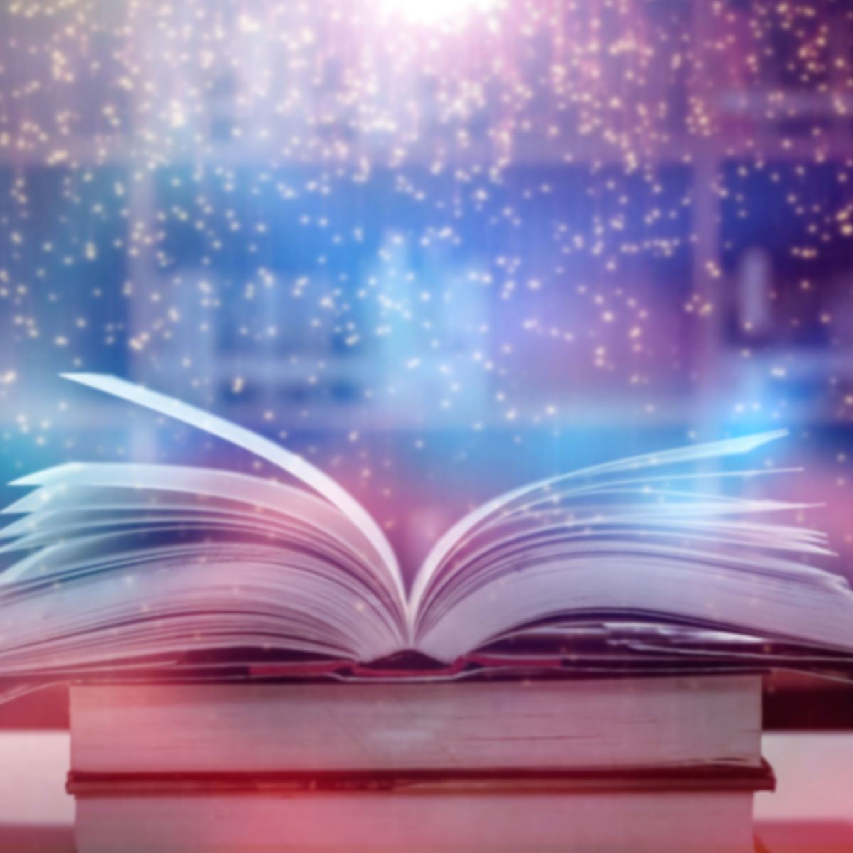Open book with magical light and starry background symbolising Akashic Records.