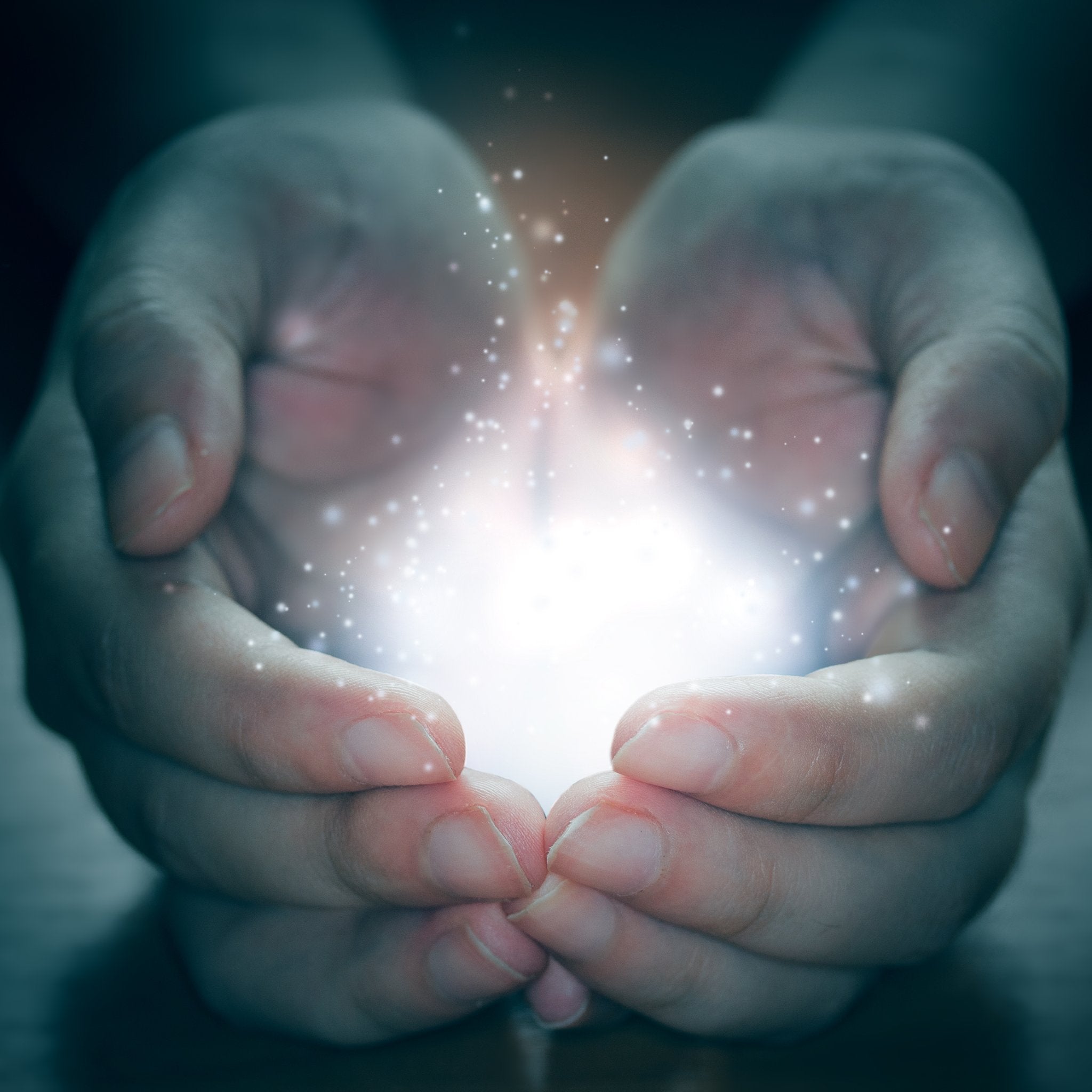 Cupped hands holding a brilliant white light and sparkling energy, symbolising the focused flow and initiation of the awakening rite.