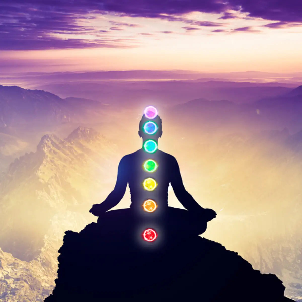 An illustration of a person meditating with spiritual light and chakras looking out over a mountainous distance represents the benefits of distant energy-healing treatments.