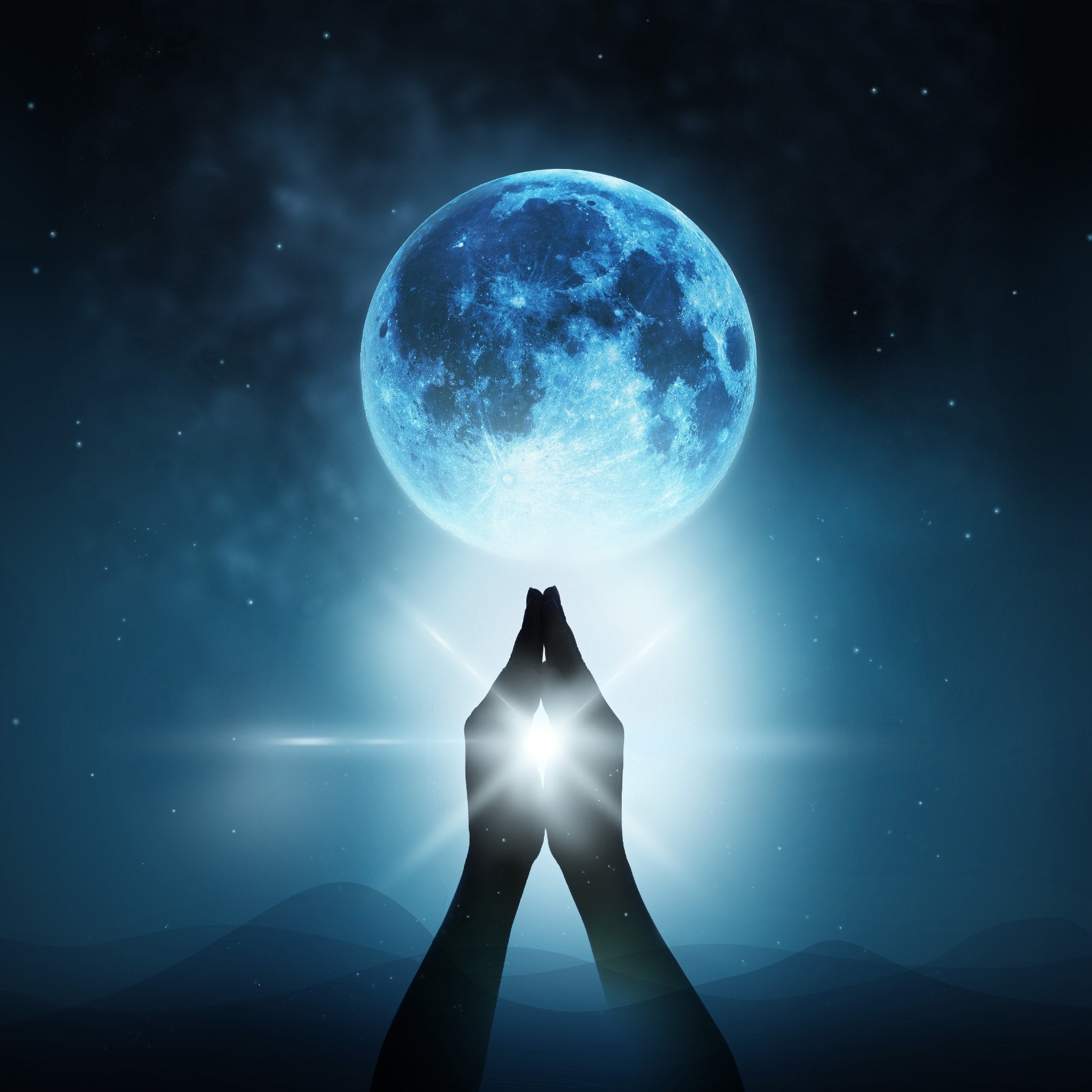 A dark silhouette of two hands held up in a prayer position against a night sky. The hands are illuminated by a brilliant white light radiating from them, which is directed upward towards a large, vivid, blue-tinged full moon hanging above a dark, rolling horizon.