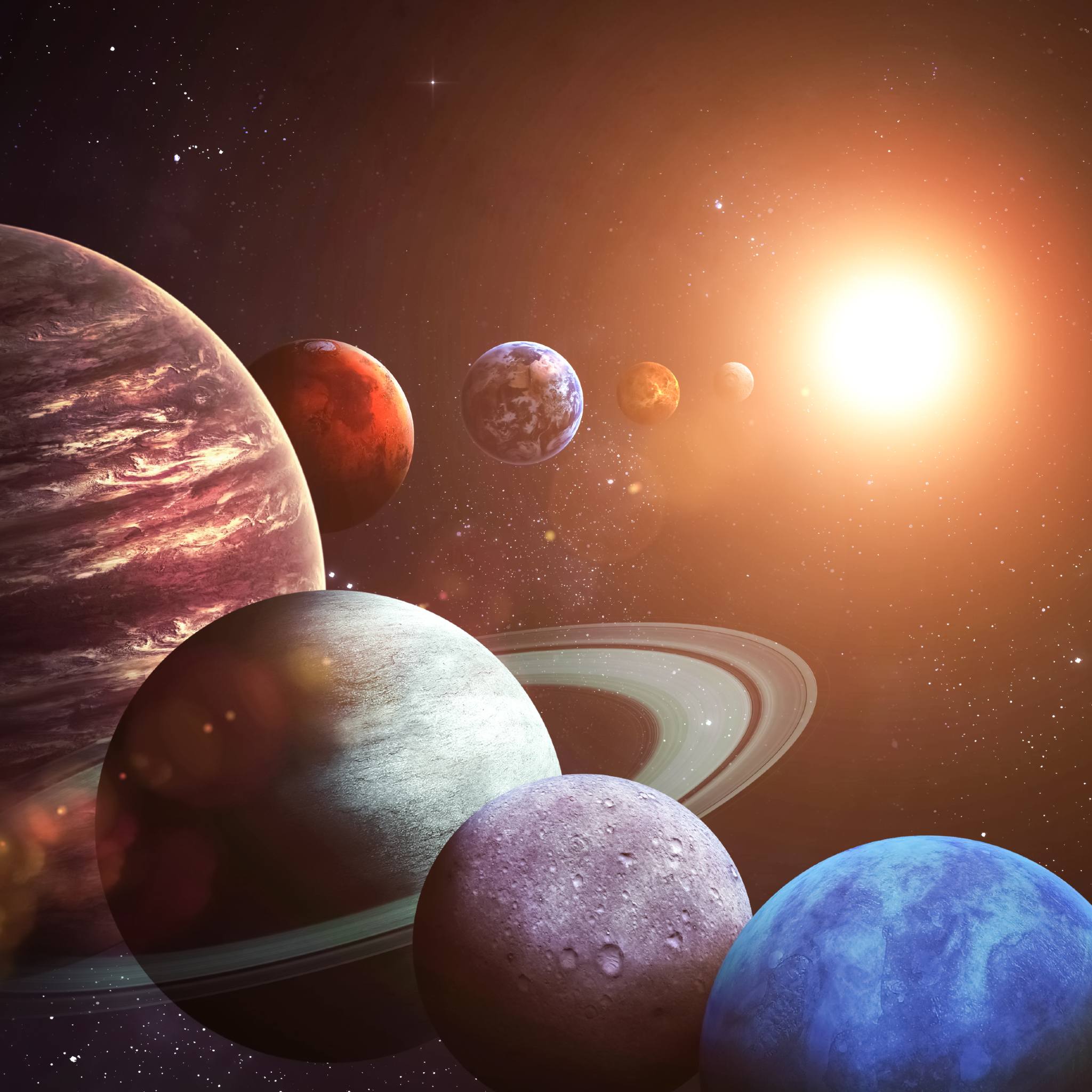 A vibrant, close-up composite image of the solar system with several colourful, stylised planets and moons, including a large ringed planet, clustered near a bright, glowing sun against a dark, starry backdrop.