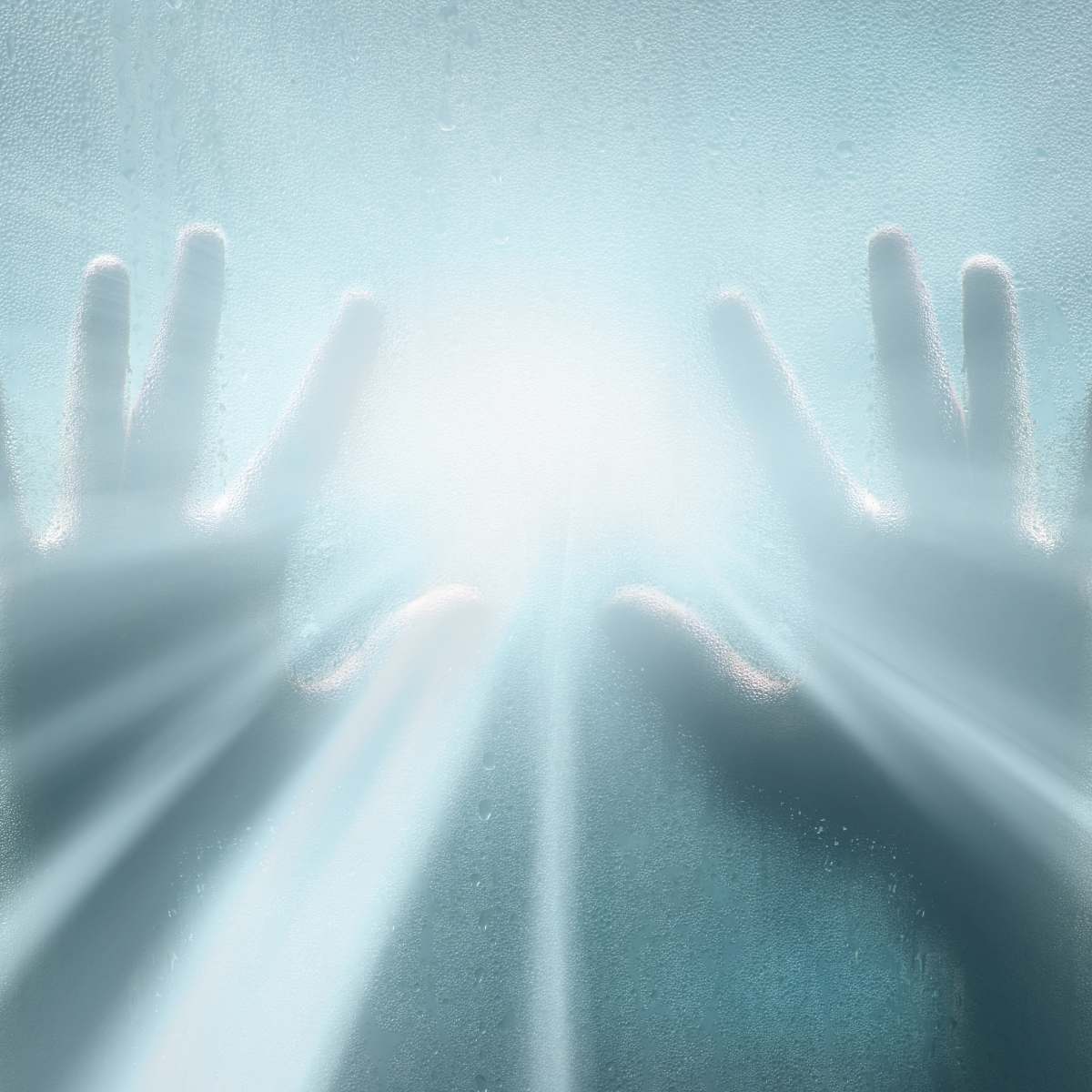 Hand shadows on a light blue glass surface symbolising clairtangency.