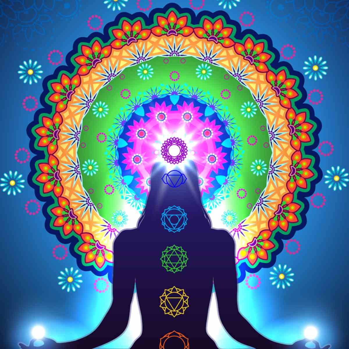 Meditating figure against a bright blue background, with seven main chakras glowing and a large, vibrantly coloured mandala centred around the glowing Crown Chakra.