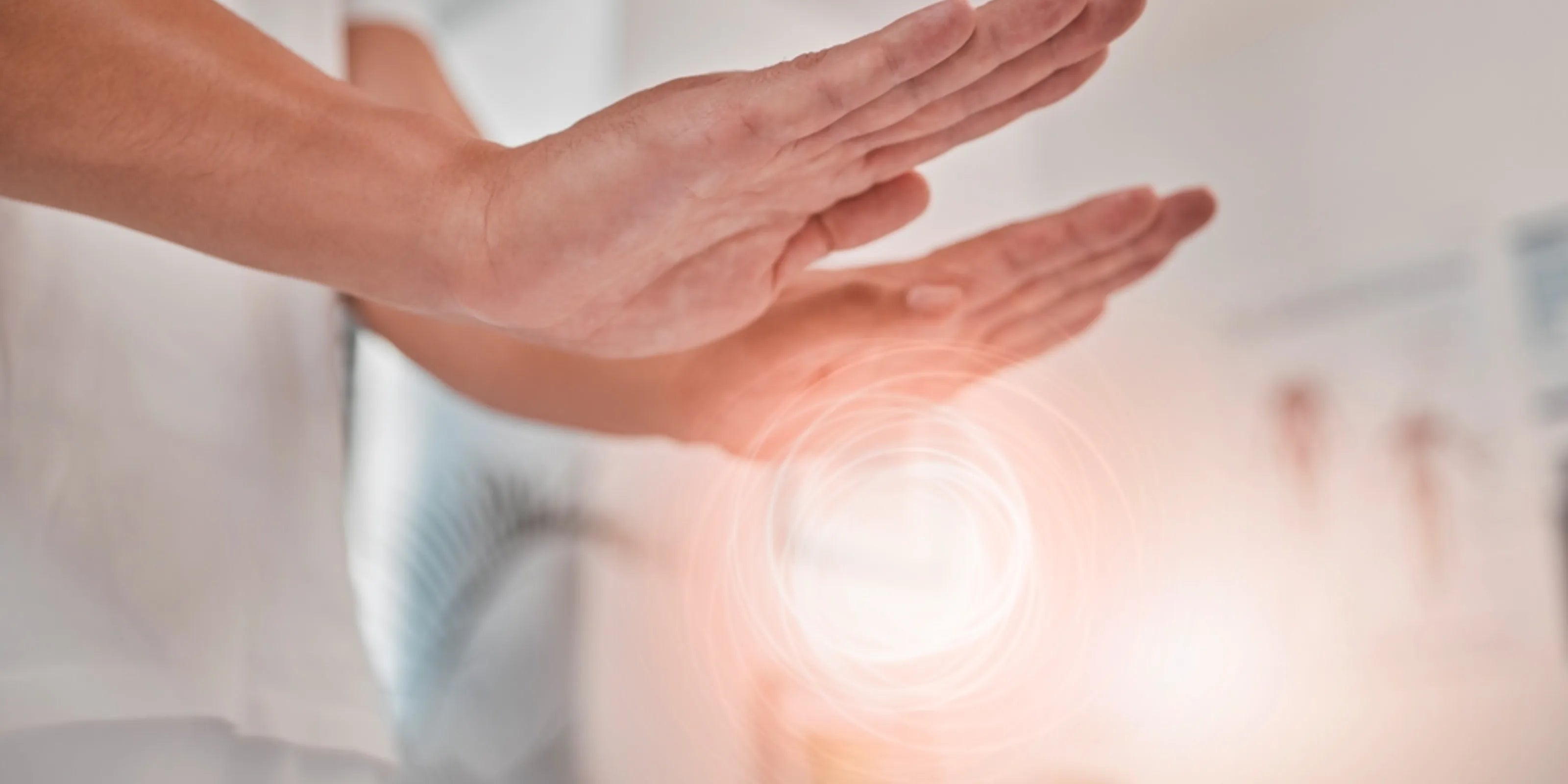Hands performing a remote (distant) attunement, with a glowing energy circle symbolising healing energy.
