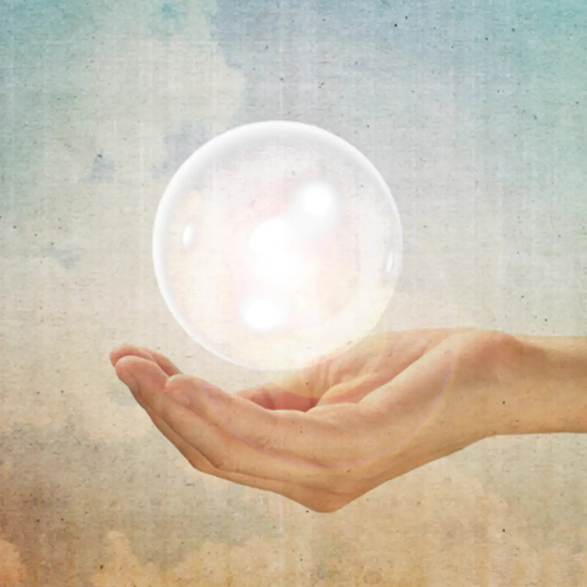 Distant attunements illustration: hand holding glowing energy sphere.