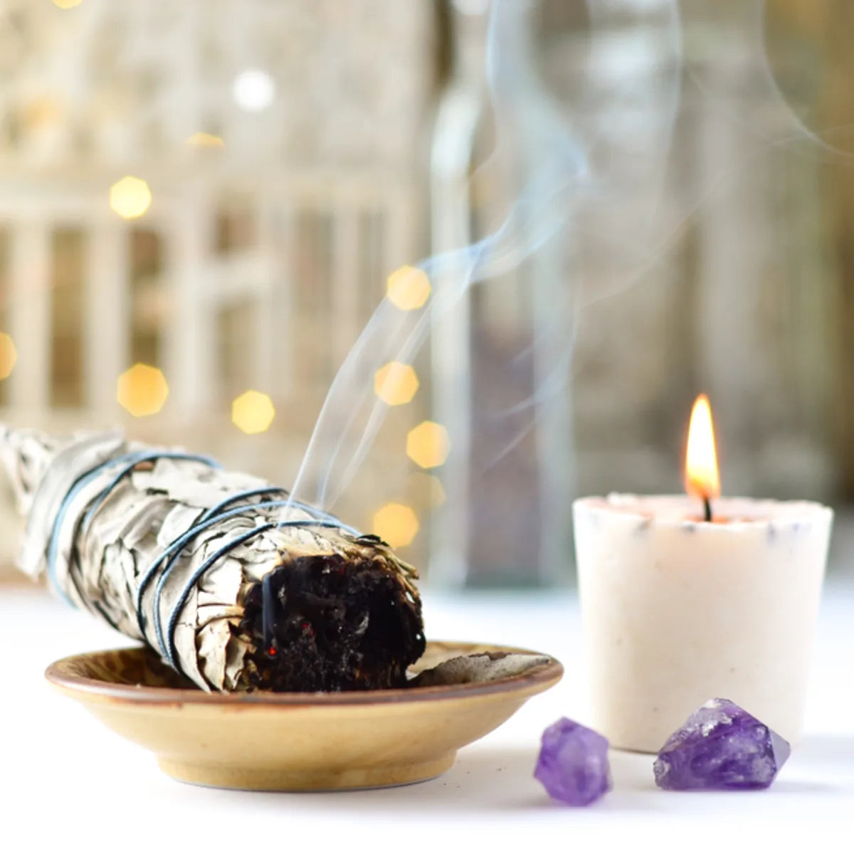 Distant energy healing treatments: burning sage, candle, and amethyst.