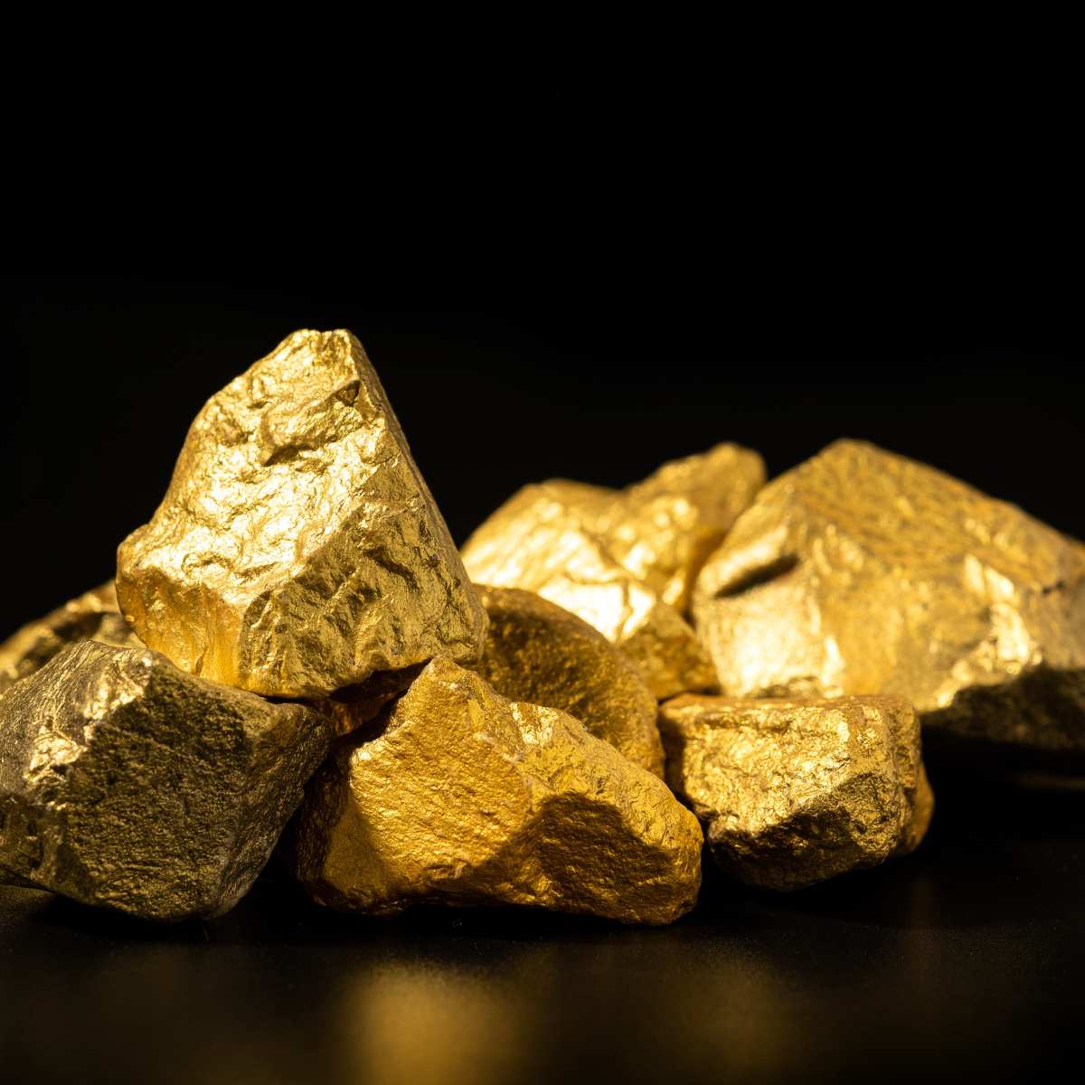 Close-up of gold rocks on a black background.