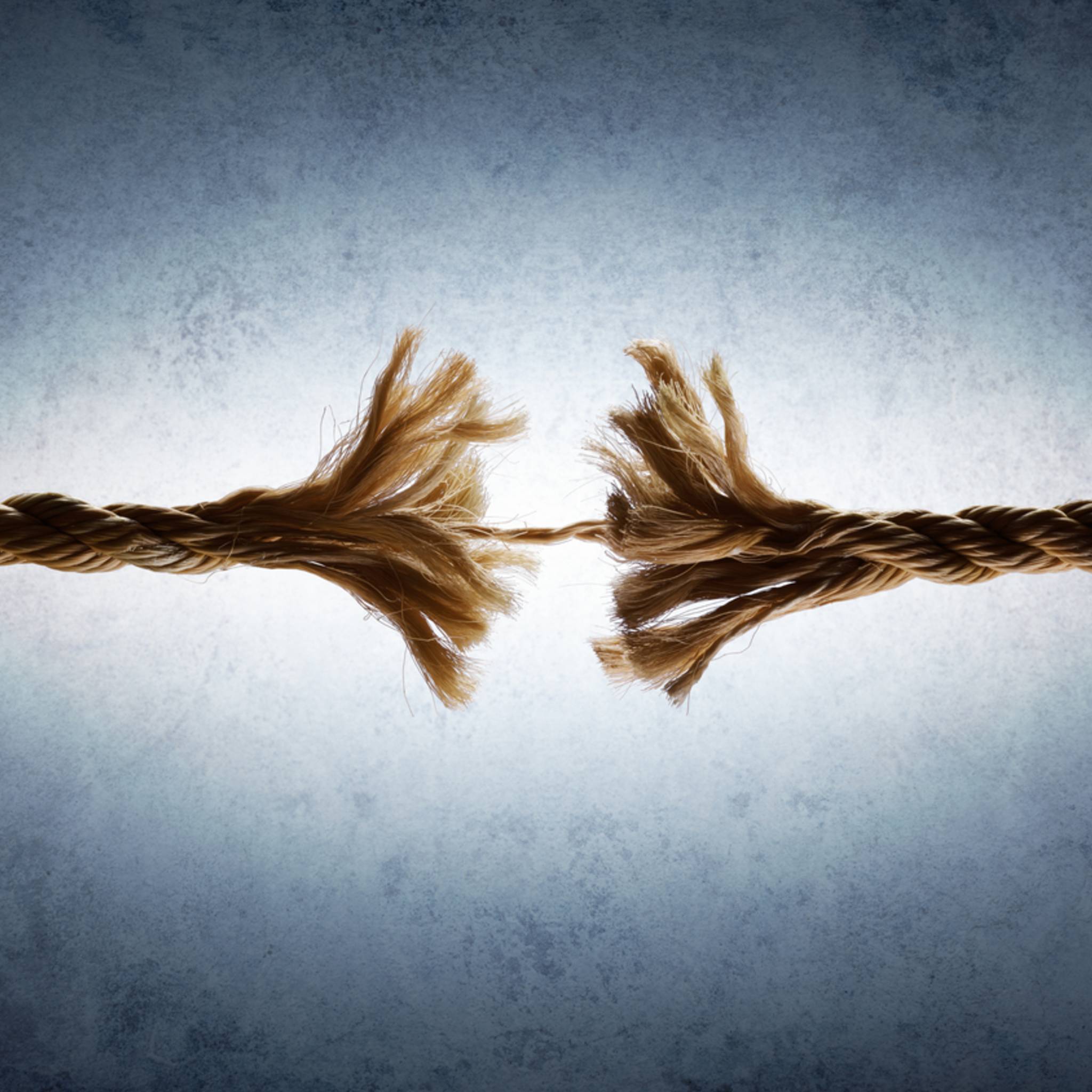 Etheric Cord Cutting Treatment: two ends of a broken rope on a textured grey background symbolising non-serving etheric cord removal.