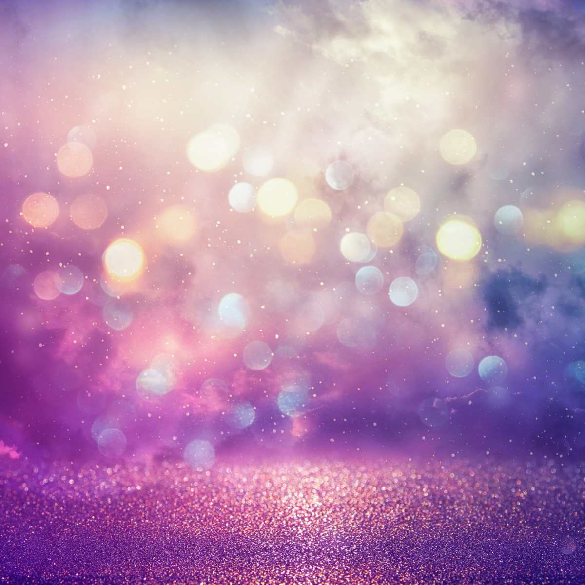 Bokeh effect with purple and pink hues on a blurred background representing fire fairy magic.