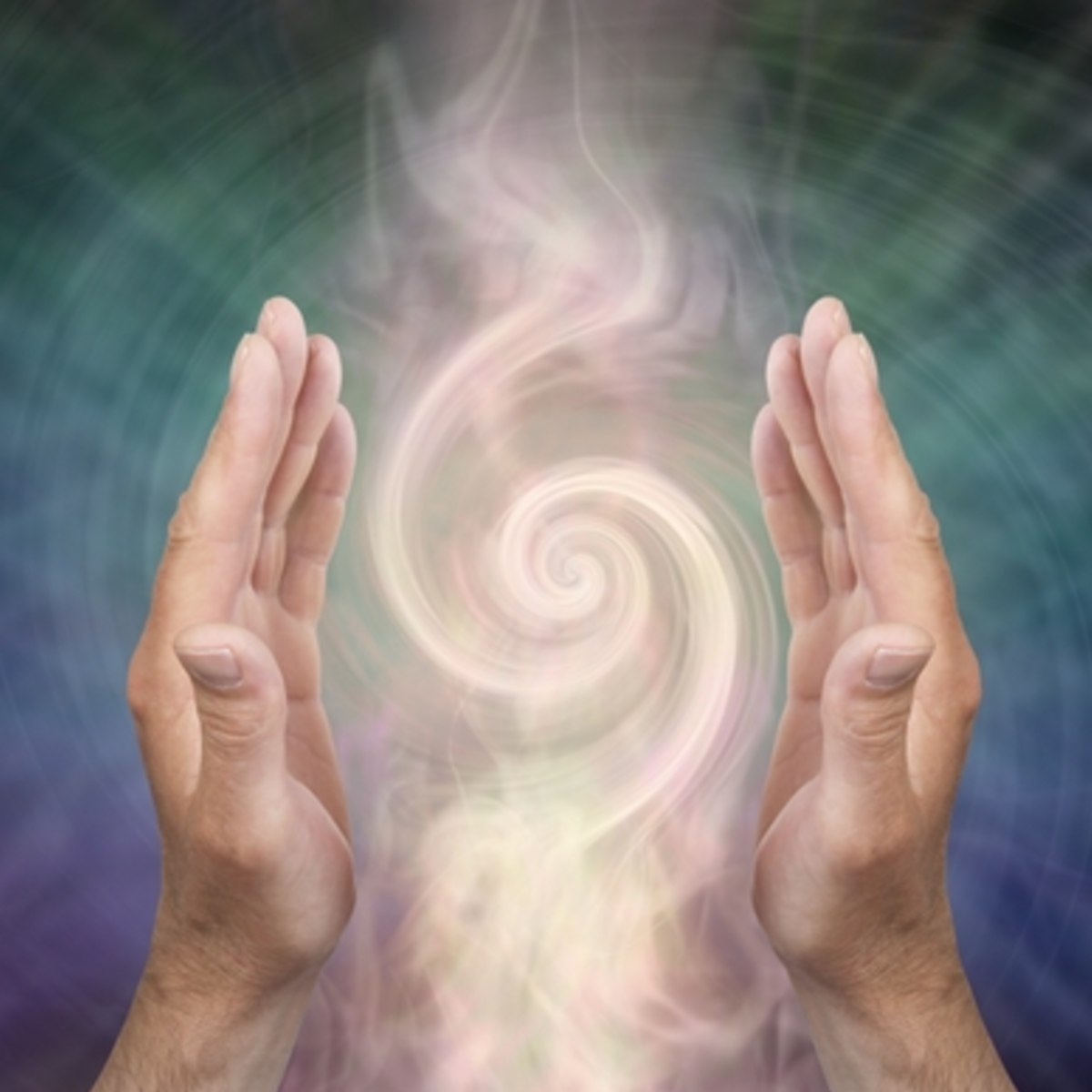 Two hands raised towards a swirling energy field with a multicoloured background.