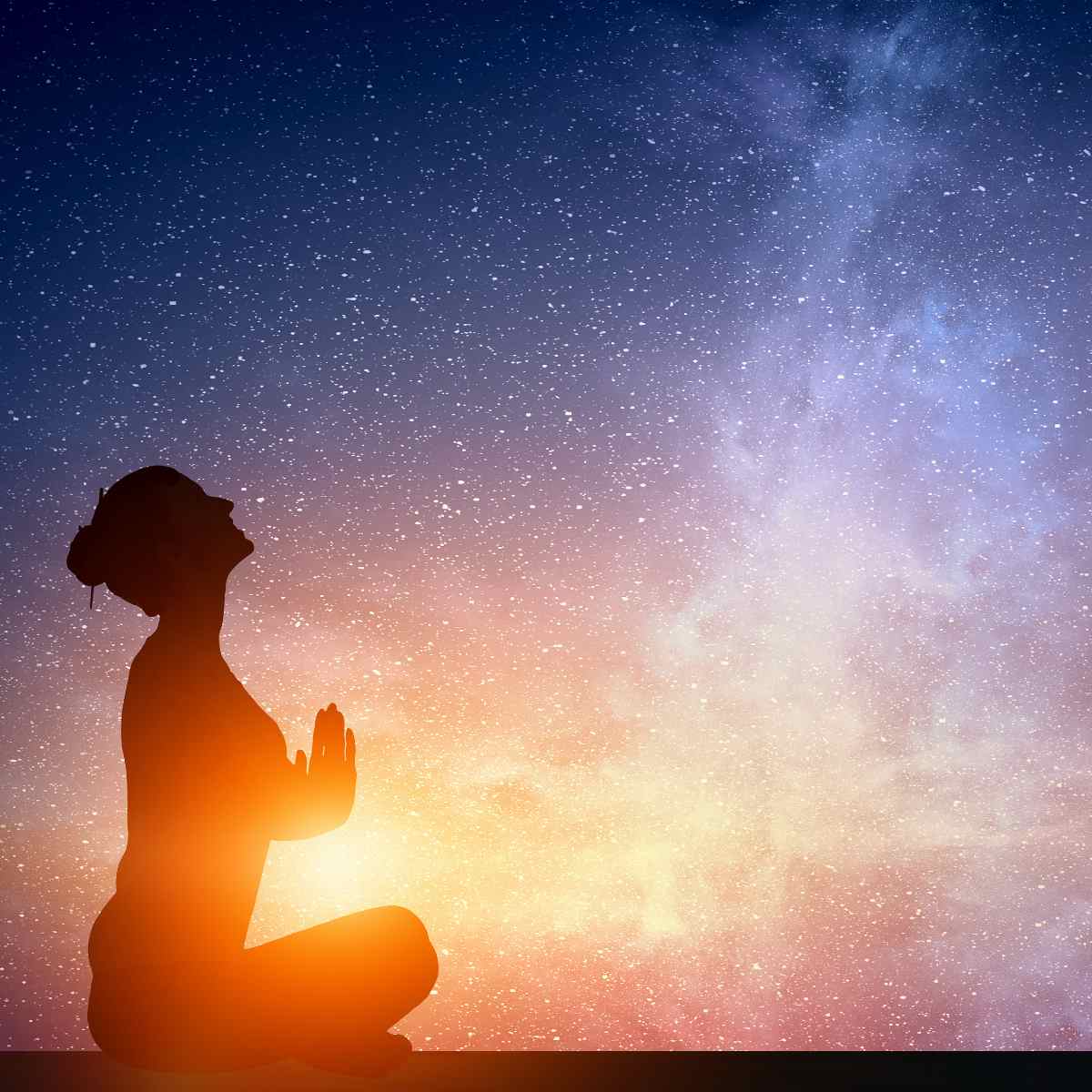 Silhouette of a person meditating against a starry night sky with a colourful gradient.