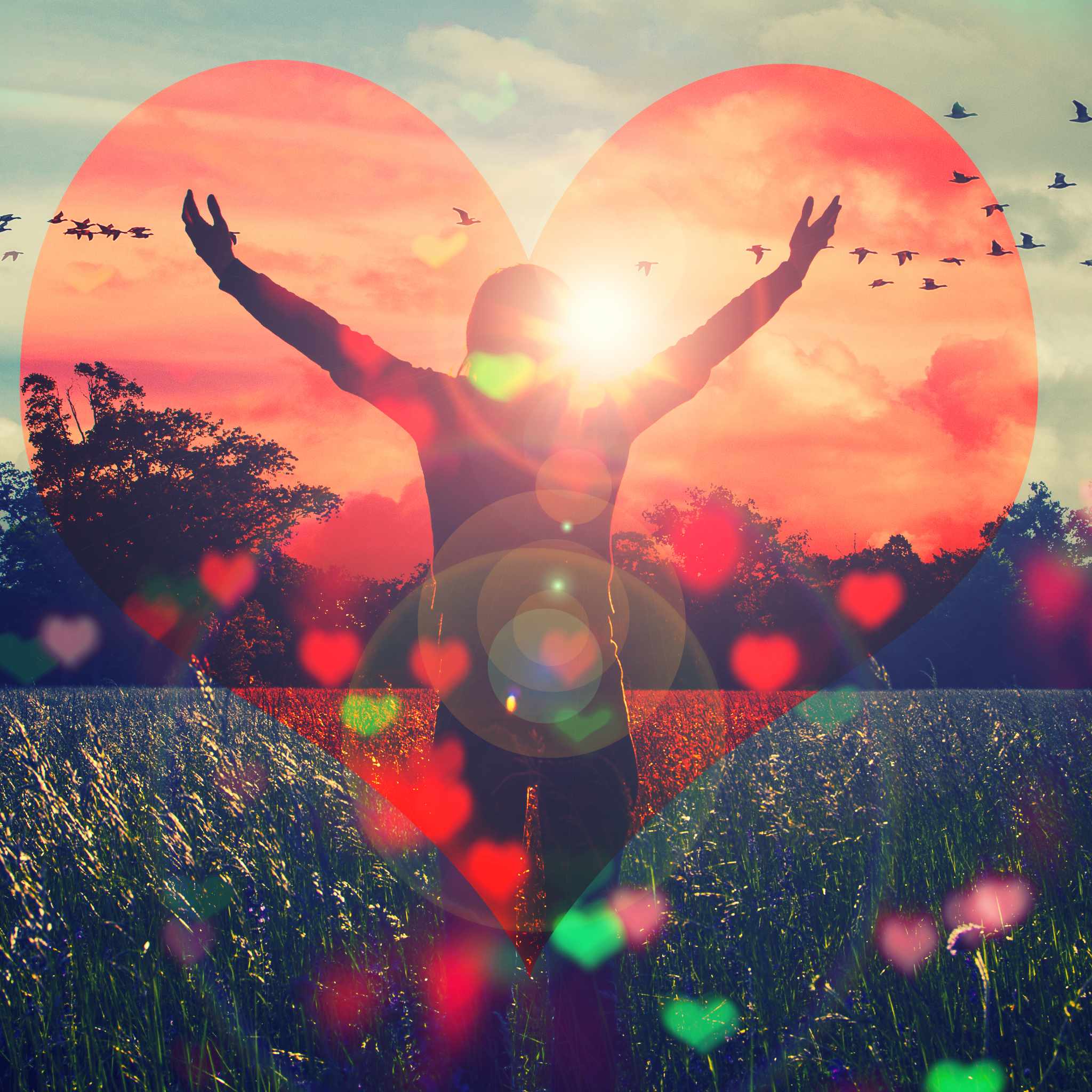 A double-exposure image where a person with their arms raised in a gesture of freedom stands silhouetted against a sunset, surrounded by trees and a field. The scene is framed inside a large, glowing red heart shape, with smaller hearts scattered in the foreground.