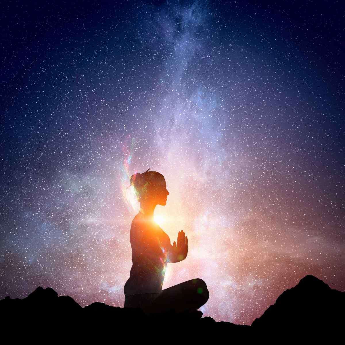 Person meditating with a starry night sky and galaxy in the background.