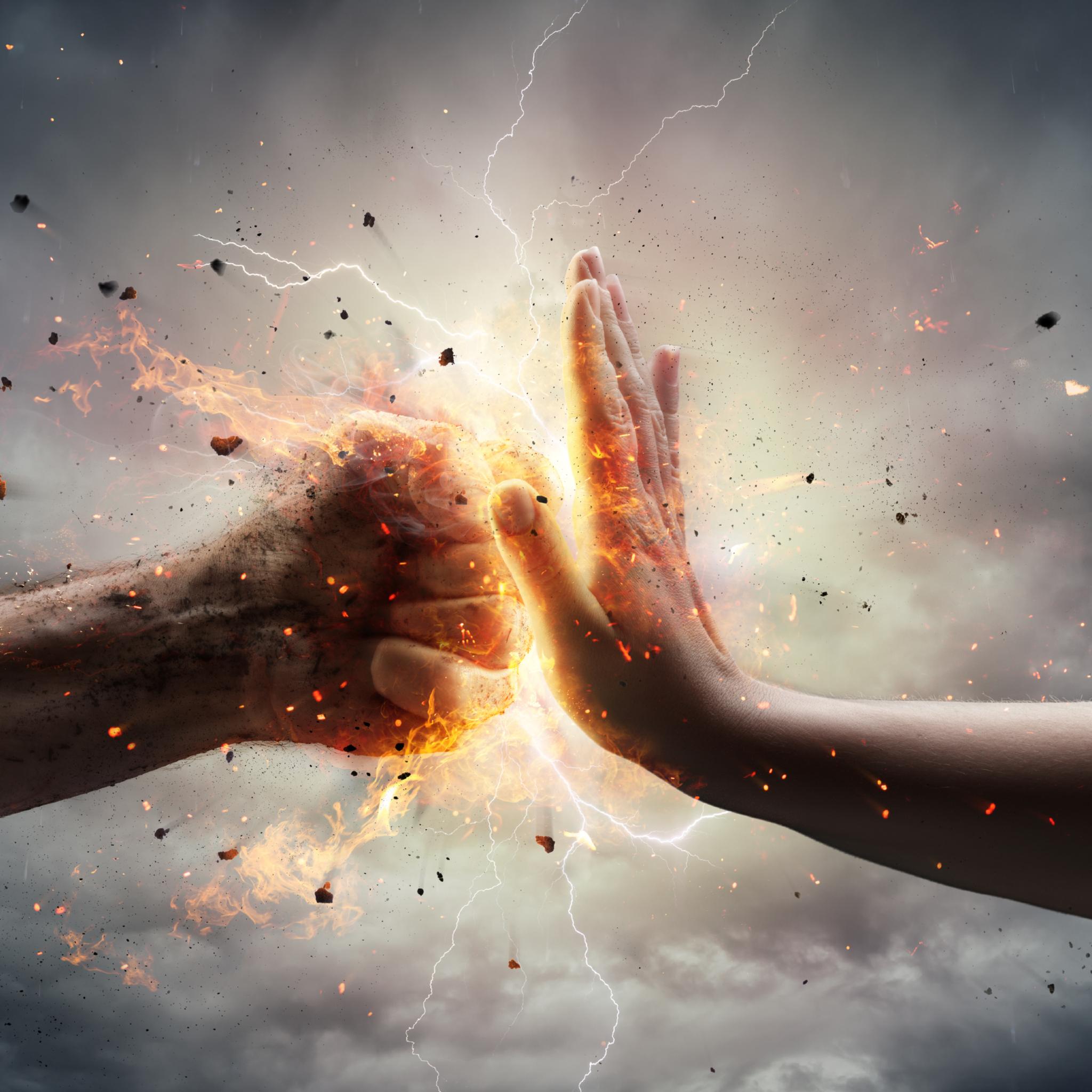 A human fist and an open palm meet in the centre, generating a burst of fiery orange energy, sparks, and lightning against a stormy, dramatic background, visually depicting a powerful energetic block.