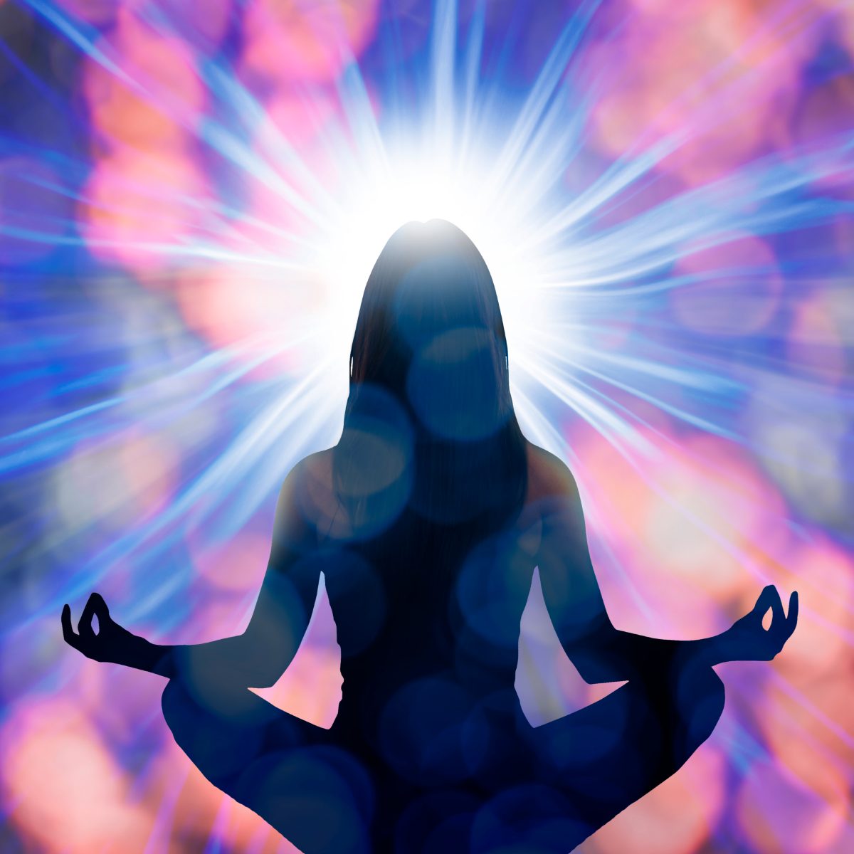 Silhouette of a person meditating with a radiant Reiki light effect on a colourful background.
