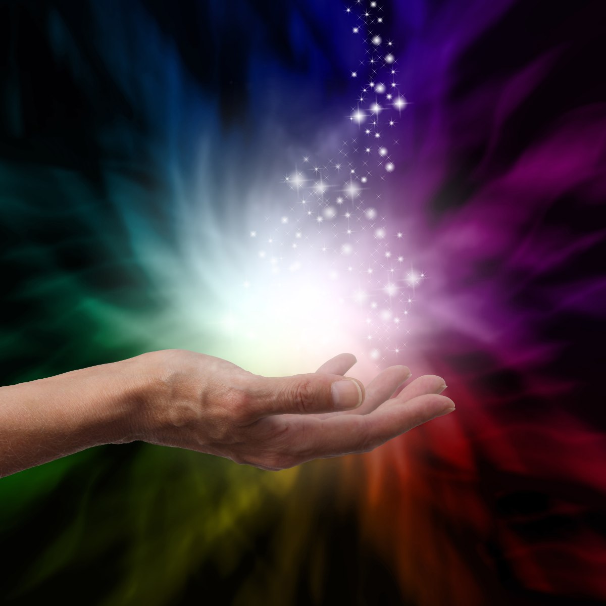 Hand holding a bright Reiki energy source with a colourful background.