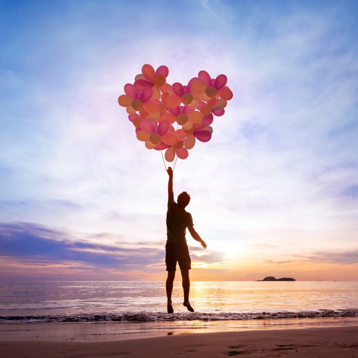 A silhouette of a person jumping and holding onto pink balloons shaped like a large heart symbolising the inner child.