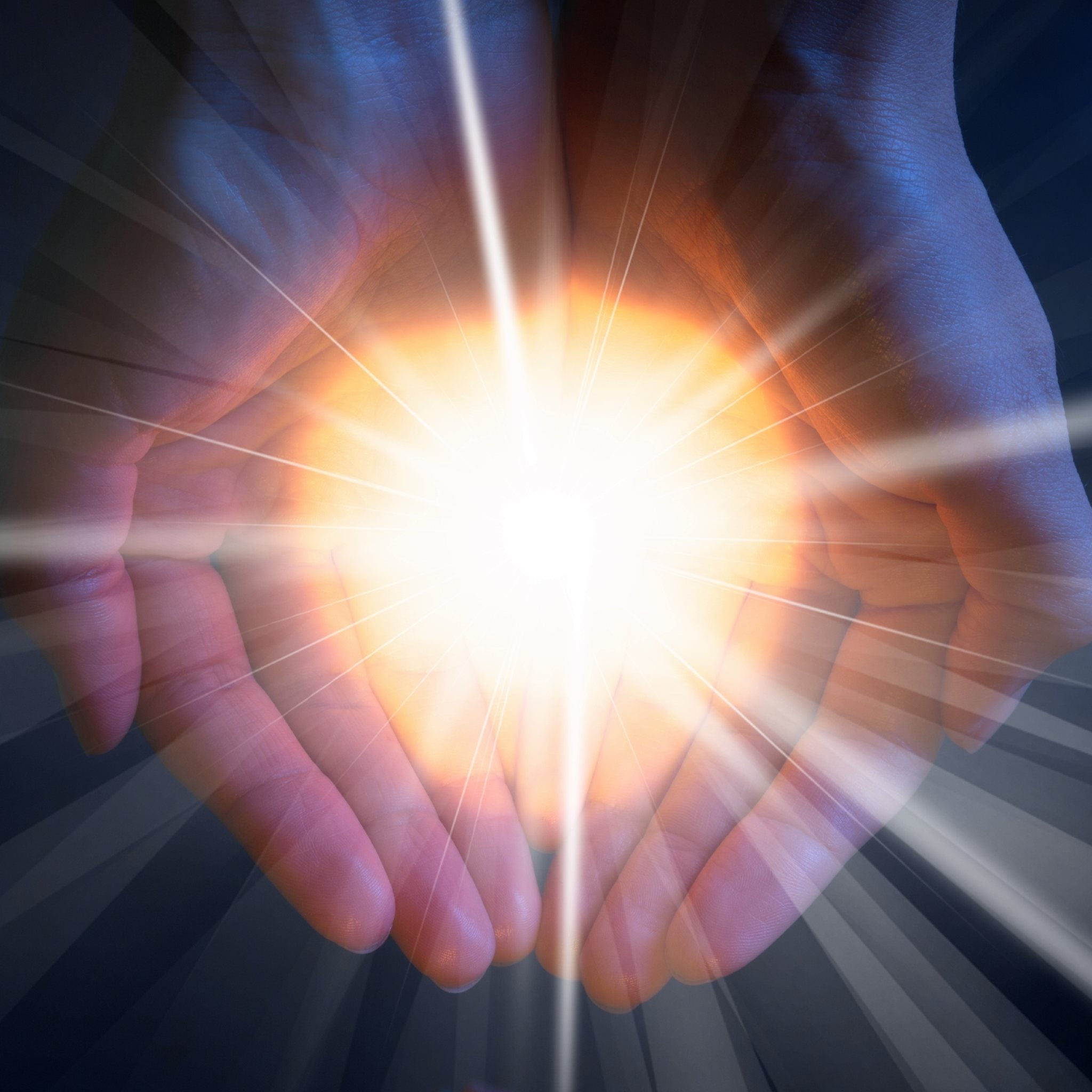 A pair of cupped human hands, bathed in an intense, warm orange and white light that flares brightly from the centre. The light radiates outward, creating streaking rays against a dark, shadowy background. This highly visual image represents soul retrieval.