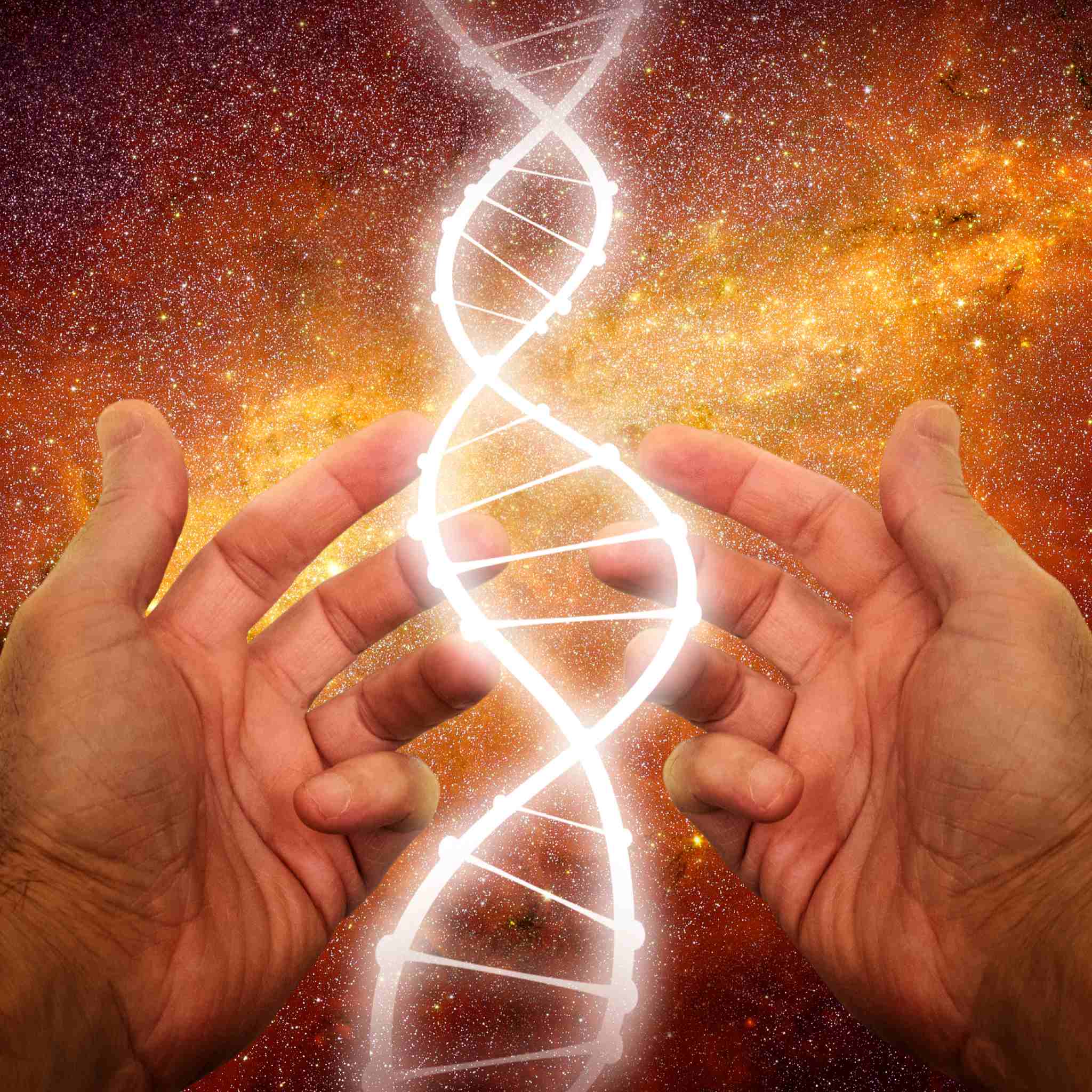 Two hands holding up a glowing white DNA double helix structure against an orange and gold starry nebula background, representing spiritual dna rite.