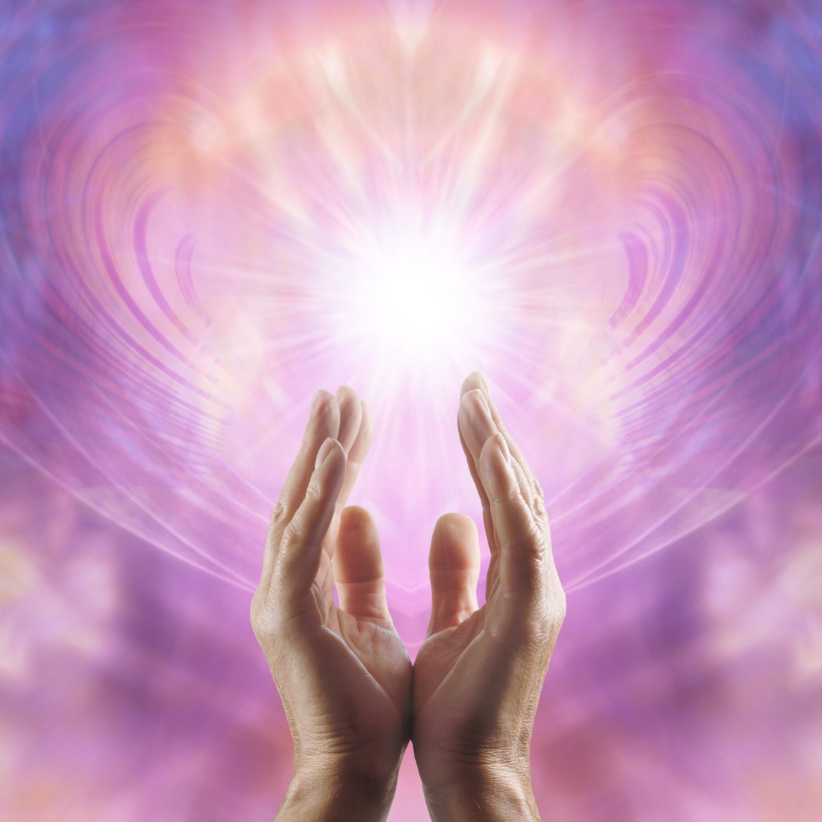 Hands held out with a radiant Reiki light and swirling energy field in the background.