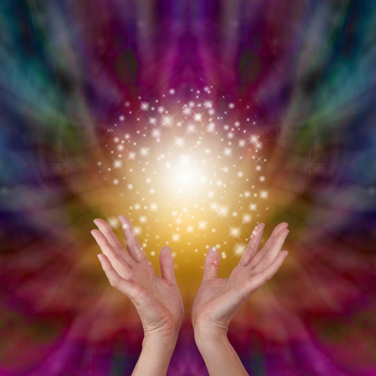Hands held open with a radiant Reiki energy and a colourful, swirling background.