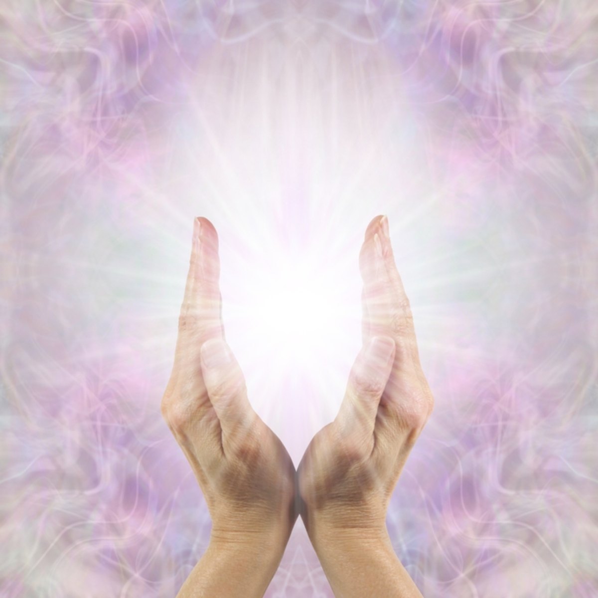 Hands held out against a soft, multicoloured background.