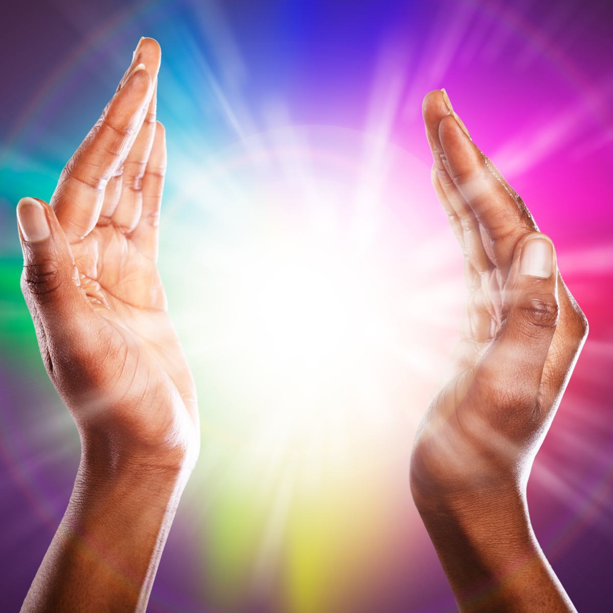Two hands raised towards each other with a colourful, radiant background.