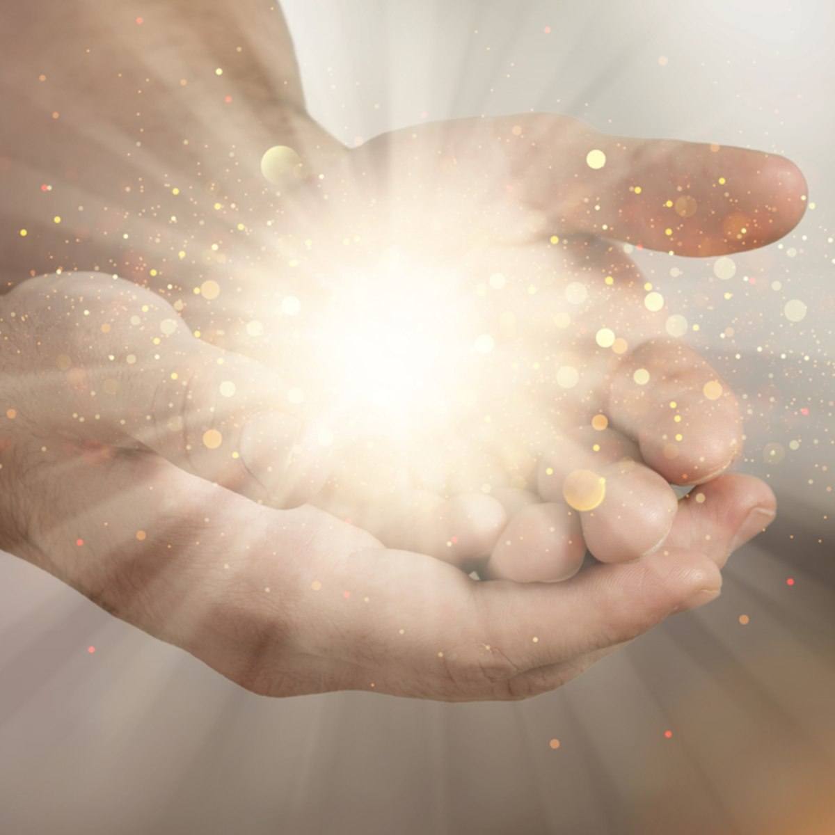 Close-up of a hand with glowing Hand Chakras with a soft focus background.