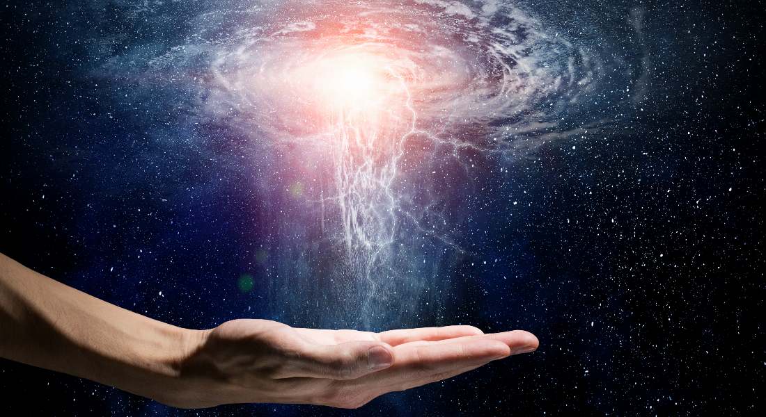 Hand holding a swirling energy vortex against a dark space background.