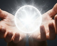 Open hands cupping a glowing white chi ball of light for a distant energy healing attunement.