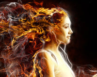 Woman with fiery hair against a dark background