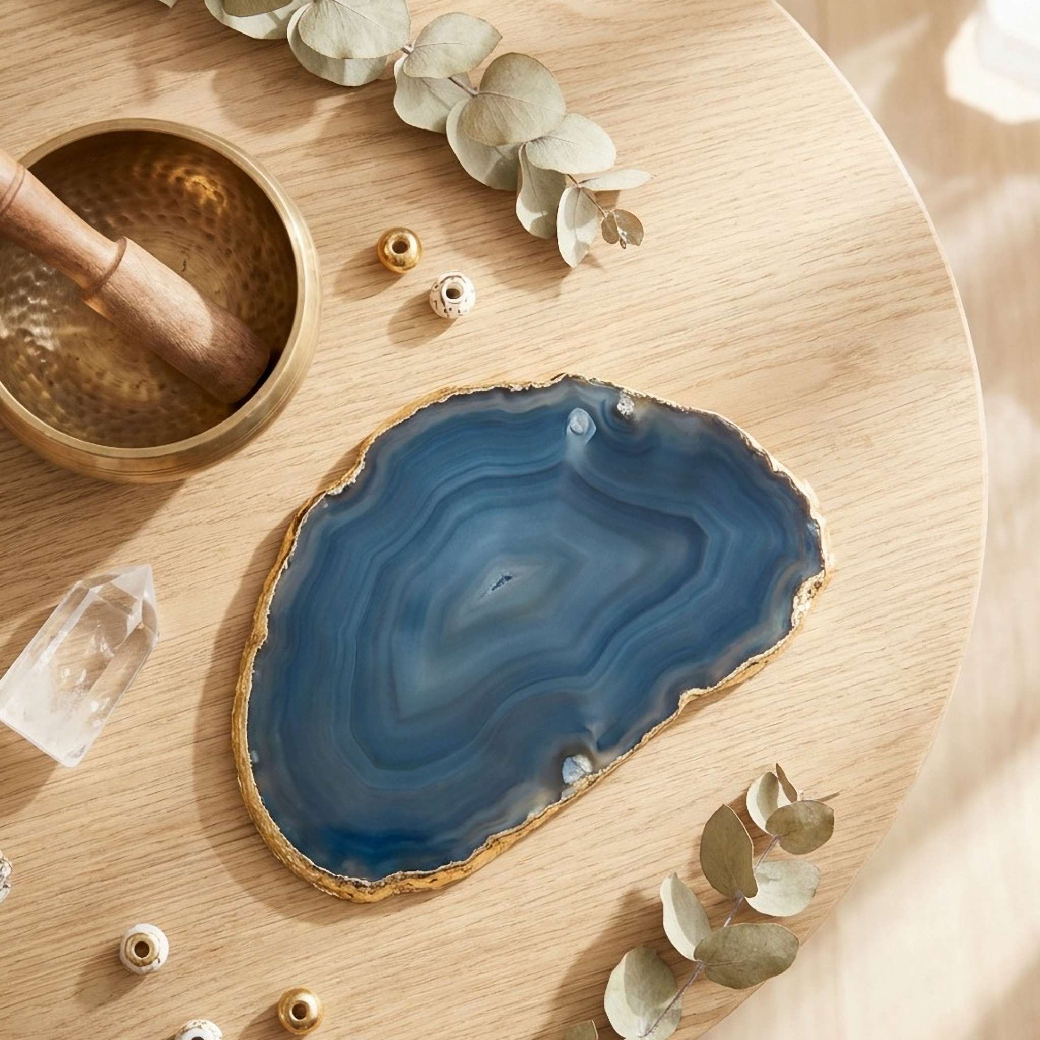 Healing tools for Craig's Top 10 Treatments: blue agate, brass singing bowl, and quartz on wood.