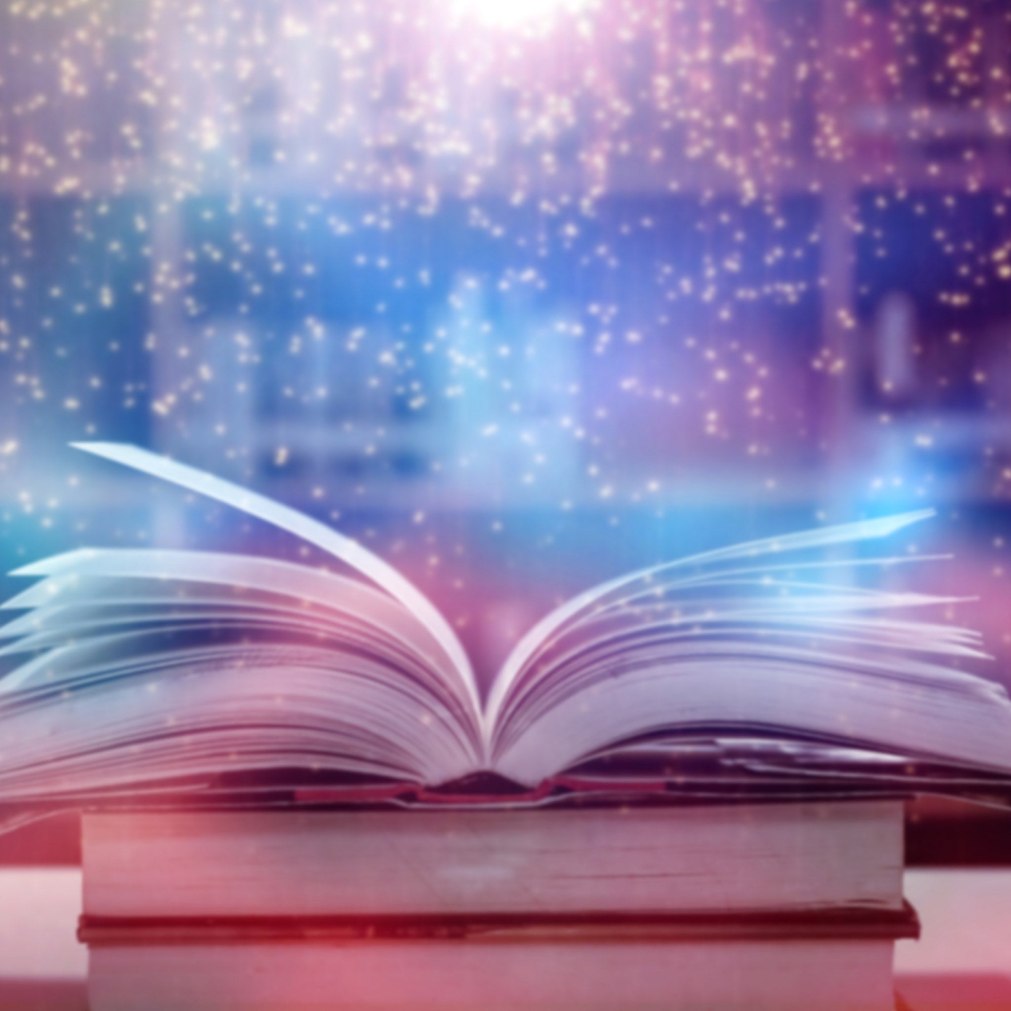 Open book with magical light and starry background symbolising Akashic Records.