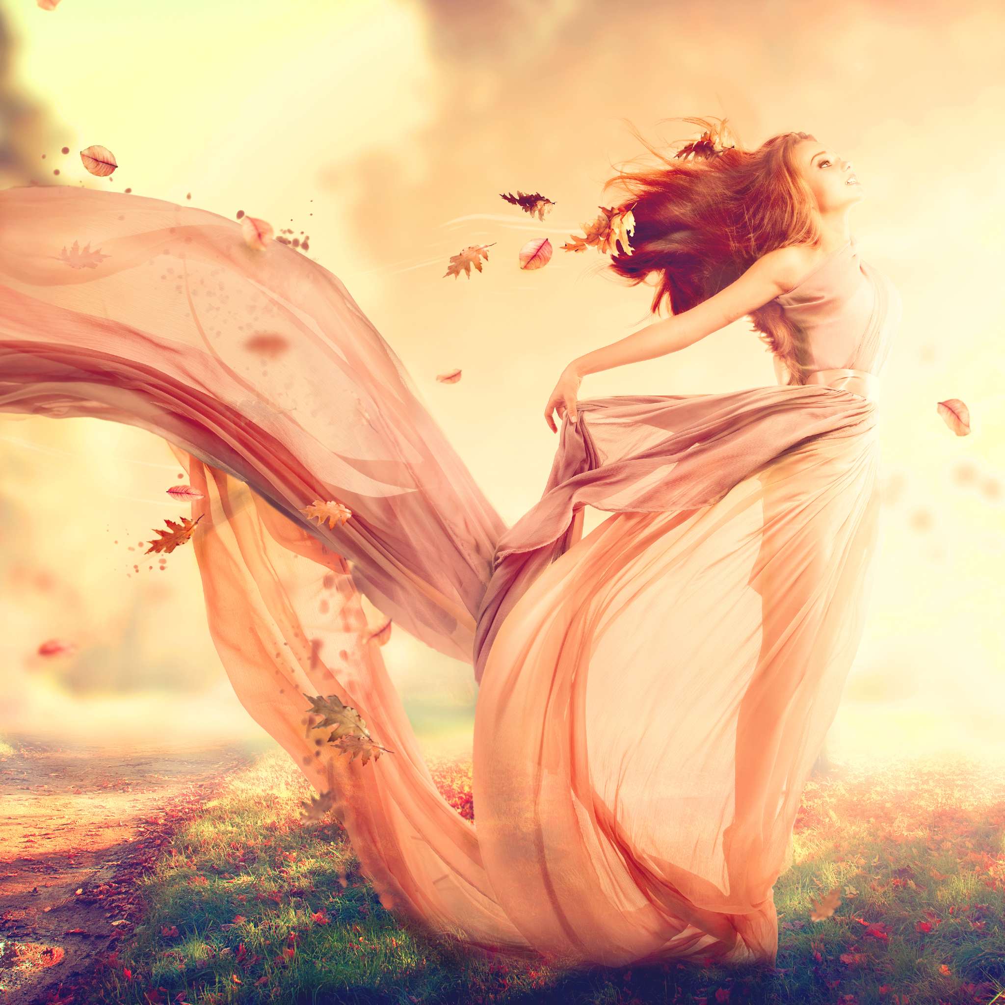 A woman in a flowing gown, with autumn leaves swirling around her, representing angels of veil removal connection.