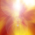 An intense abstract image of light radiating outwards from a central white point, dominated by warm colours including bright yellow, orange, and red. Numerous lens flares and soft concentric circles overlay the light beams, representing the beautiful, illuminating energy of the Archangel Jophiel.