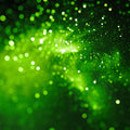 Green glittery background with a star-like focus symbolising Archangel Gabriel's energies.