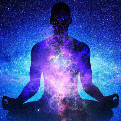 Silhouette of a person meditating with a cosmic, starry background representing the energy of the Arcturians.