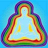 Man in meditation pose with rainbow energy circles on a blue background representing layers of the aura.