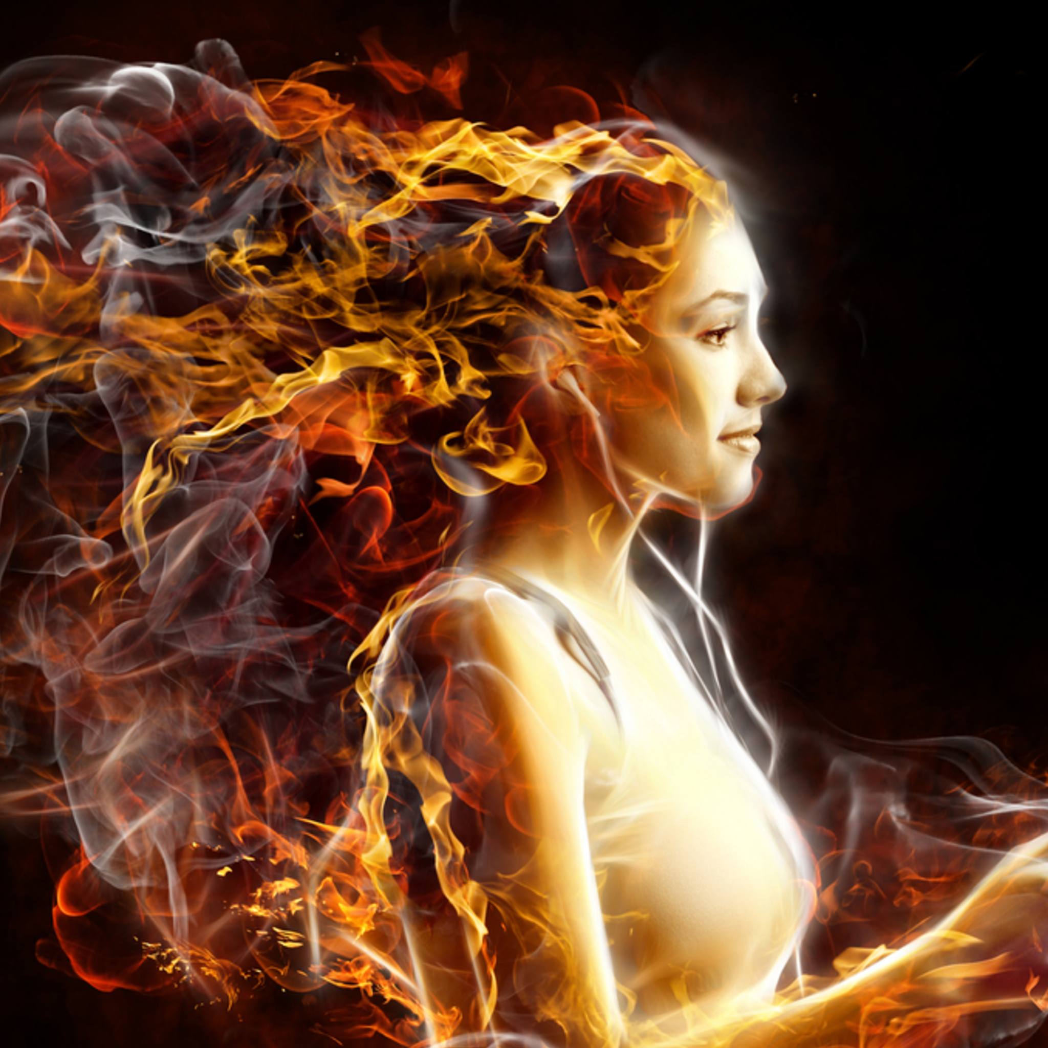 Woman with fiery hair against a dark background symbolising energetic clearing. 