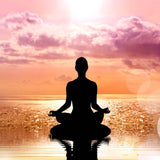 A beautiful silhouette of a person sitting in the lotus meditation pose on a calm body of water, with their reflection visible. The background is a vibrant sunset sky filled with pink and purple clouds over the horizon, representing the clarity and openness achieved through the blessing of authentic expression.