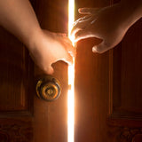 Two hands opening a wooden door with light streaming through. Symbolises energetic clearing, purification, obstacle removal, and spiritual light.