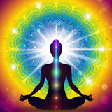 Silhouette of a person in meditation with a colourful cerebellum chakra colours on a vibrant background.