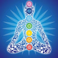 Illustration of a human figure with chakra symbols on a blue background.