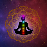 Silhouette of a person meditating with seven chakras against a starry background.