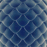 A close-up texture of deep blue dragon scales in a uniform, overlapping pattern, with subtle light highlights, representing dragon scales shielding.