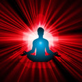 Silhouette of a meditating person with a bright light and red radiating lines in the background, representing 396 Solfege energy connections. 