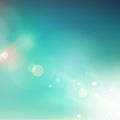 A bright, blurry abstract background in soft teal and blue, with lens flares and white light, representing Andromedan connections.